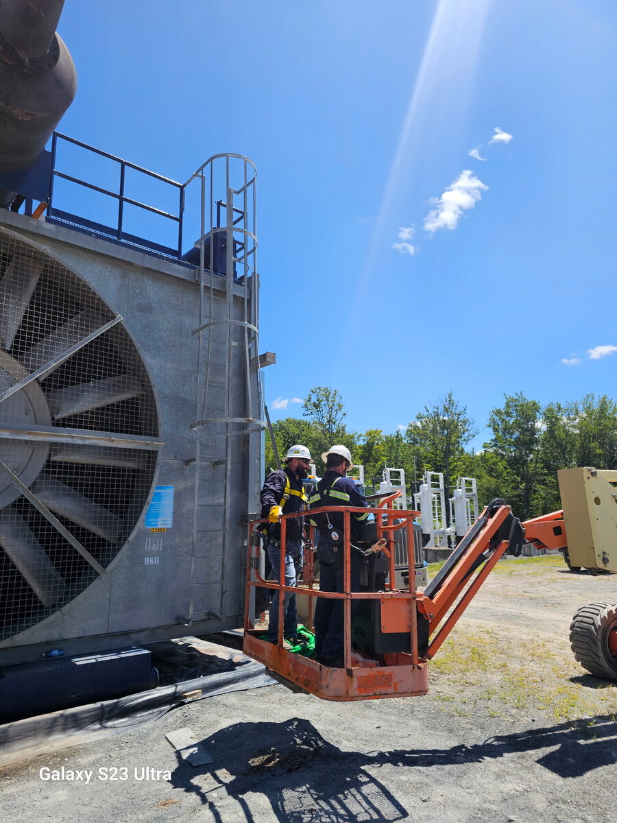 Nate Darrow working from a manlift on an industrial compression site